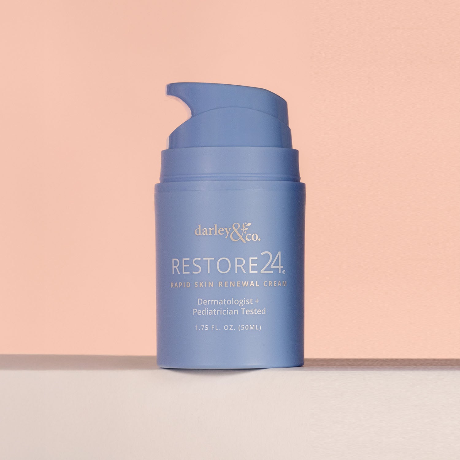 Blue RESTORE cream bottle labeled on a peach background